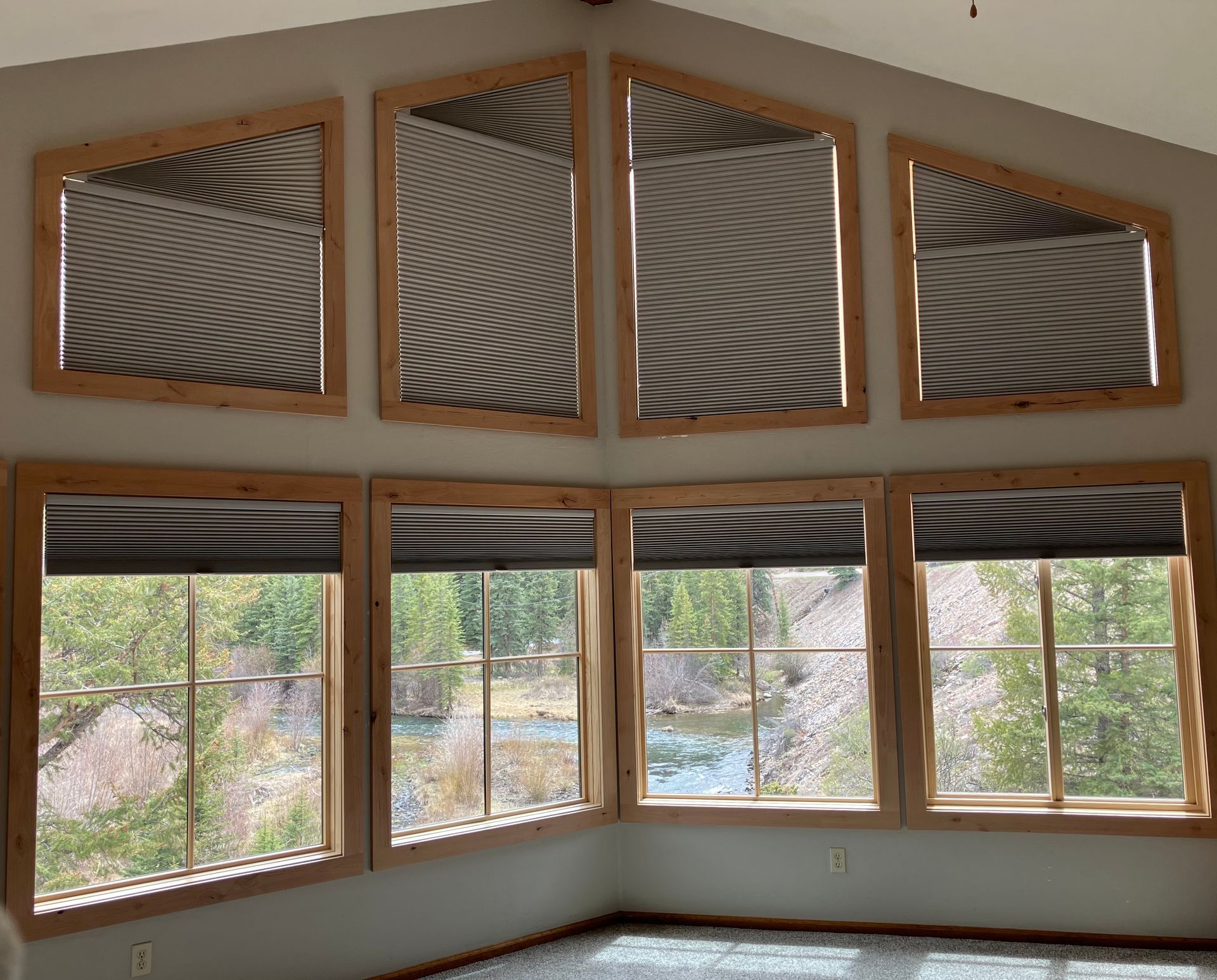 A room with a lot of windows and blinds on them