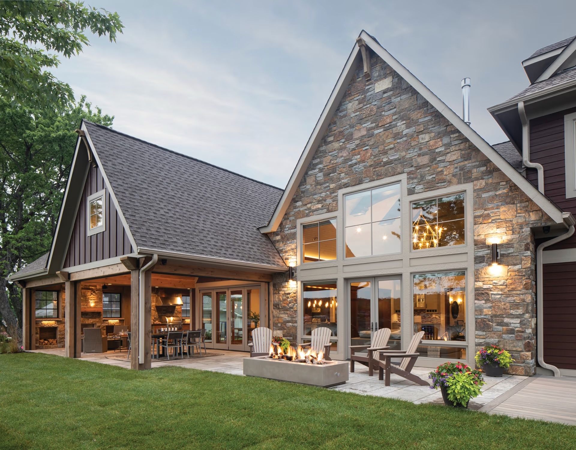 A large house with a fire pit in front of it