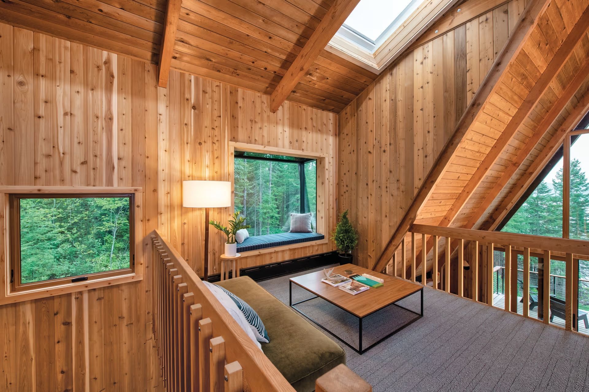 A living room with a couch , coffee table , and window.