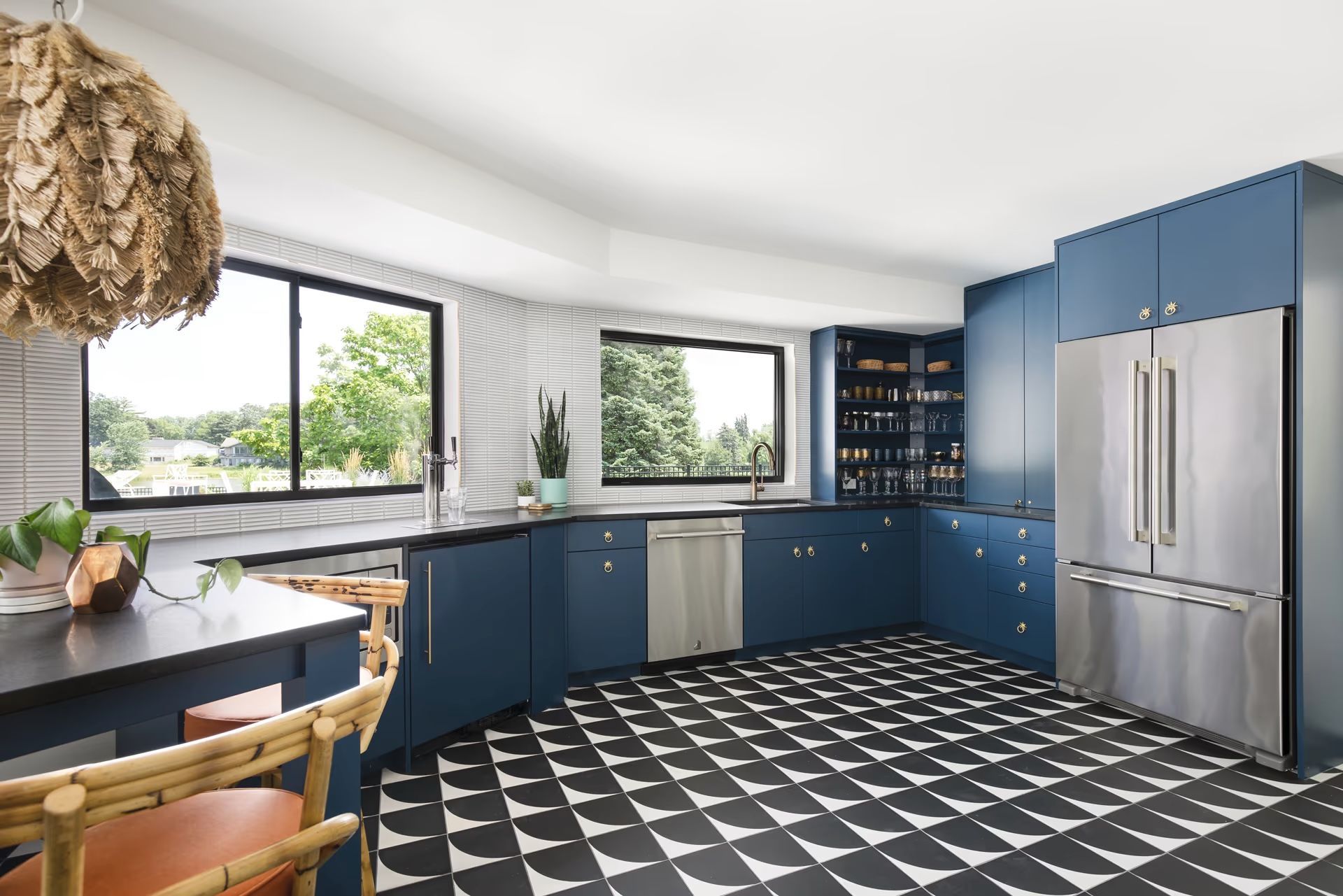 A kitchen with blue cabinets and stainless steel appliances