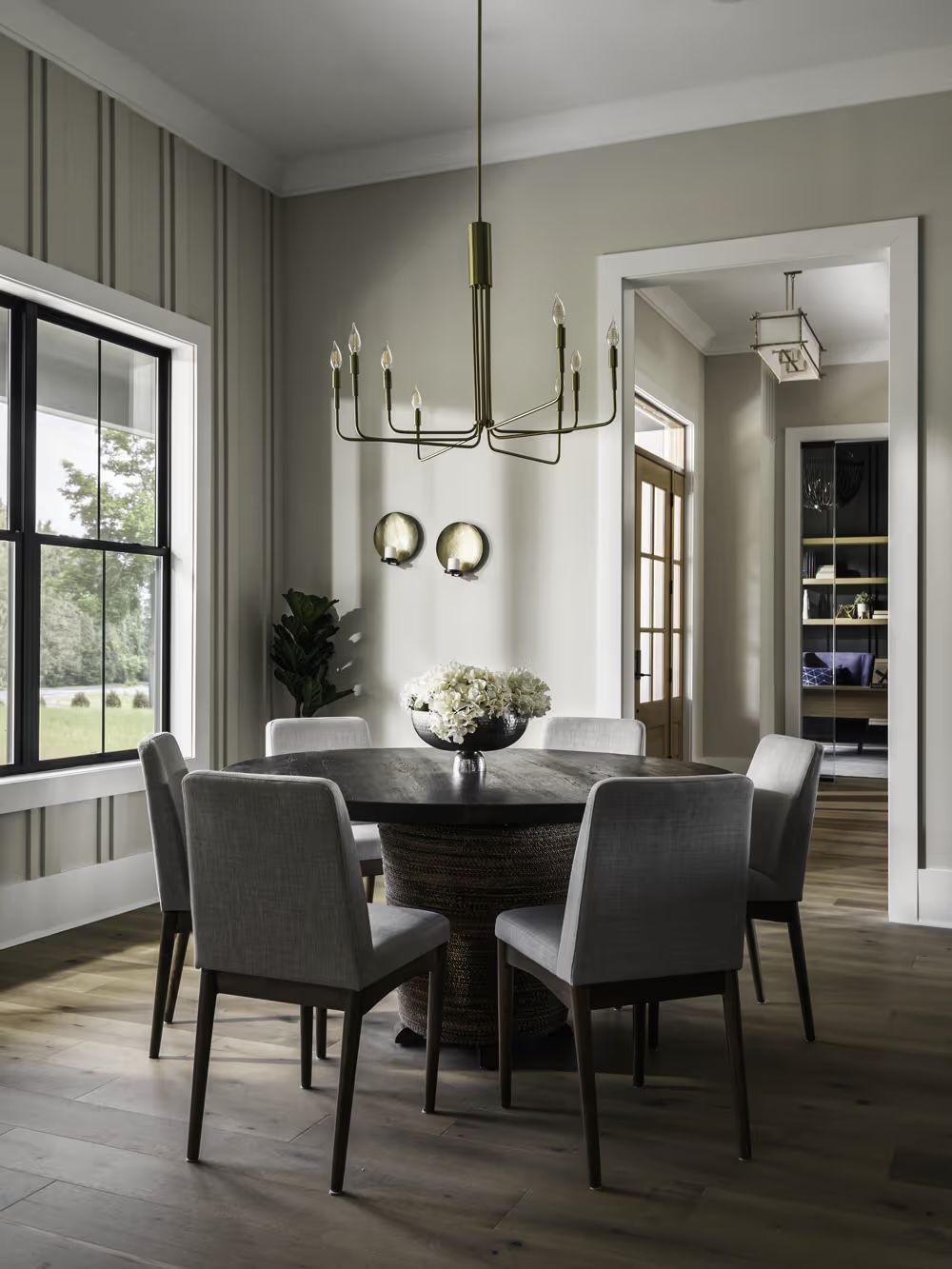A dining room with a round table and chairs