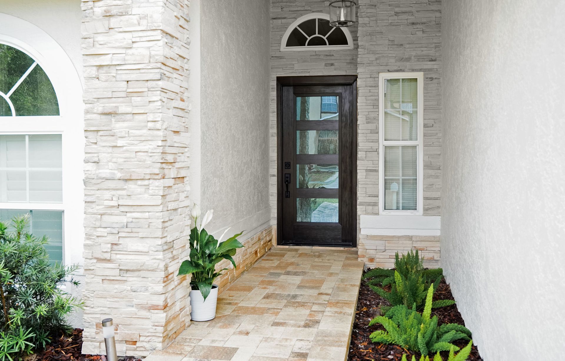 The front door of a house with a walkway leading to it.
