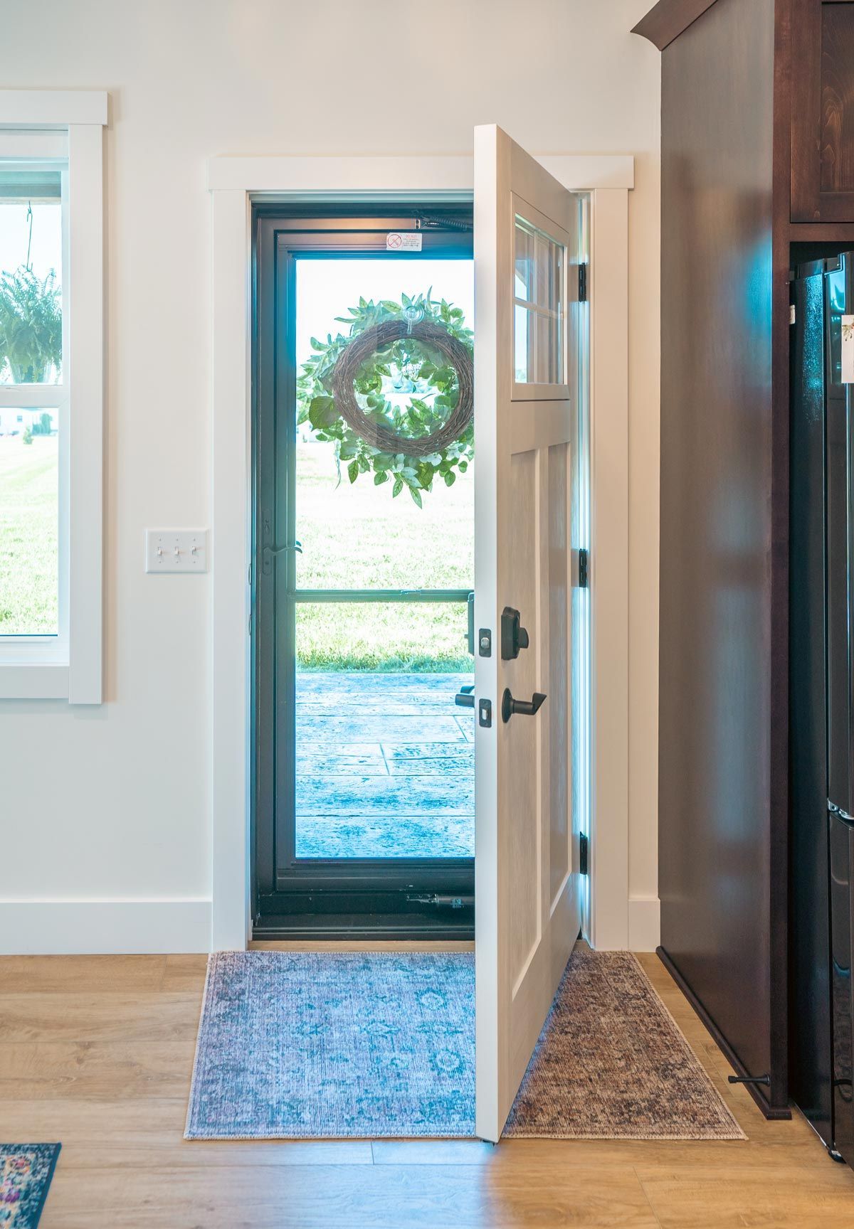 The door is open and there is a wreath on the door.