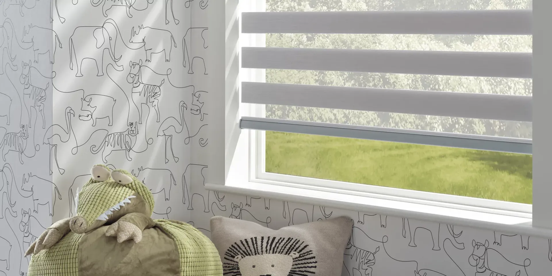 A room with a window and a pillow with a hedgehog on it.