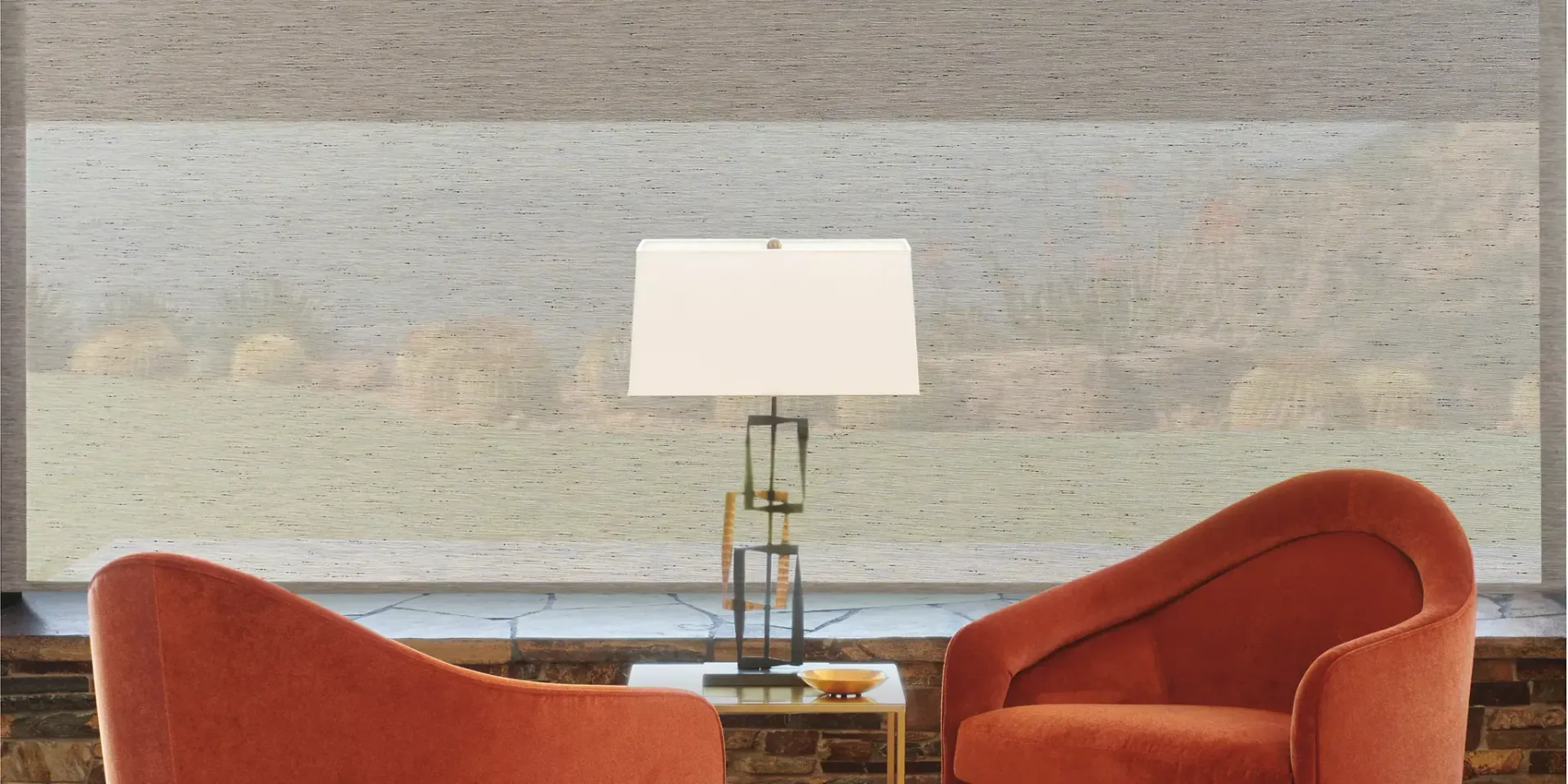 A living room with two red chairs and a lamp.