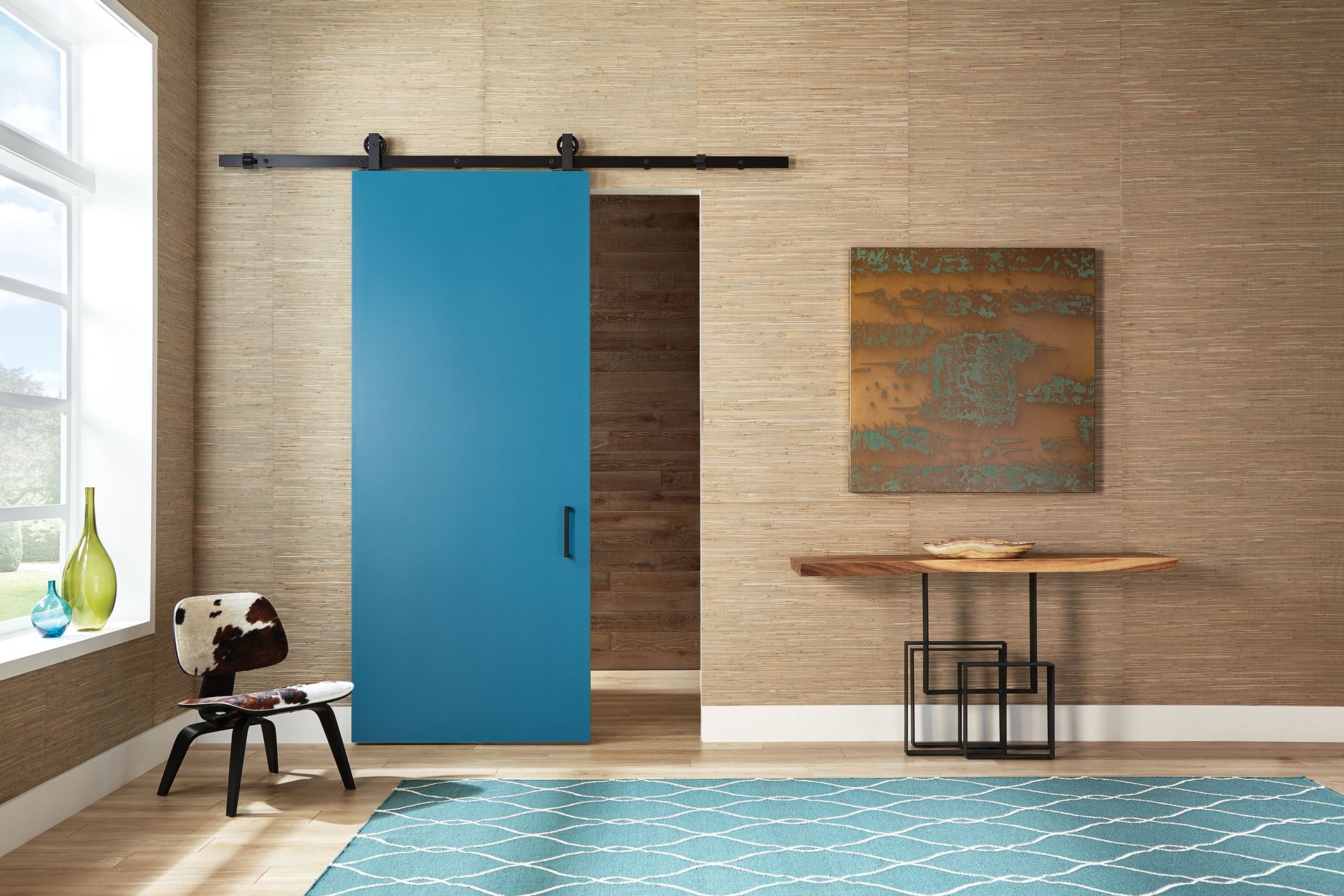 A living room with a blue sliding barn door.