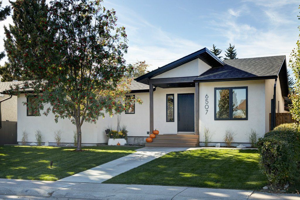 A white house with a black door and windows