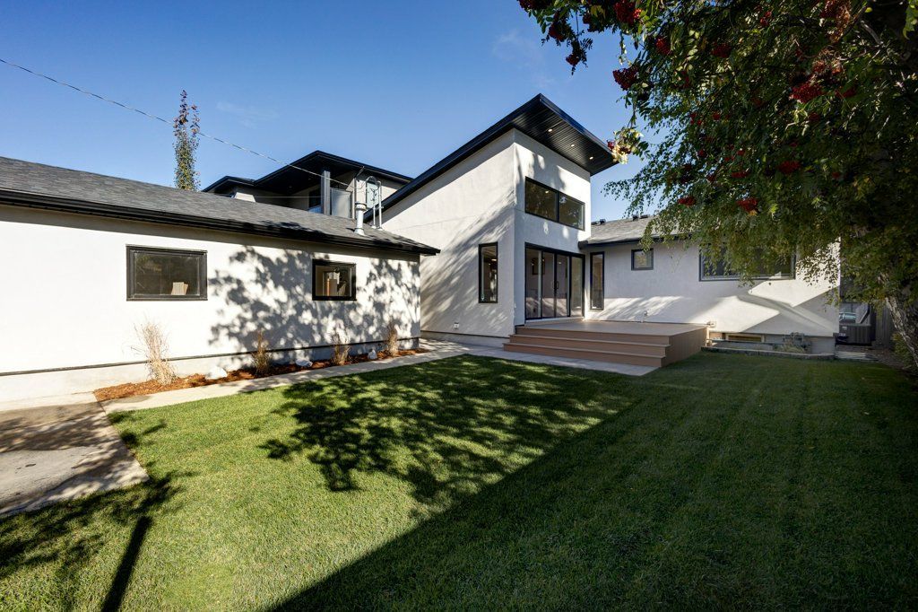 A large white house with a large lawn in front of it