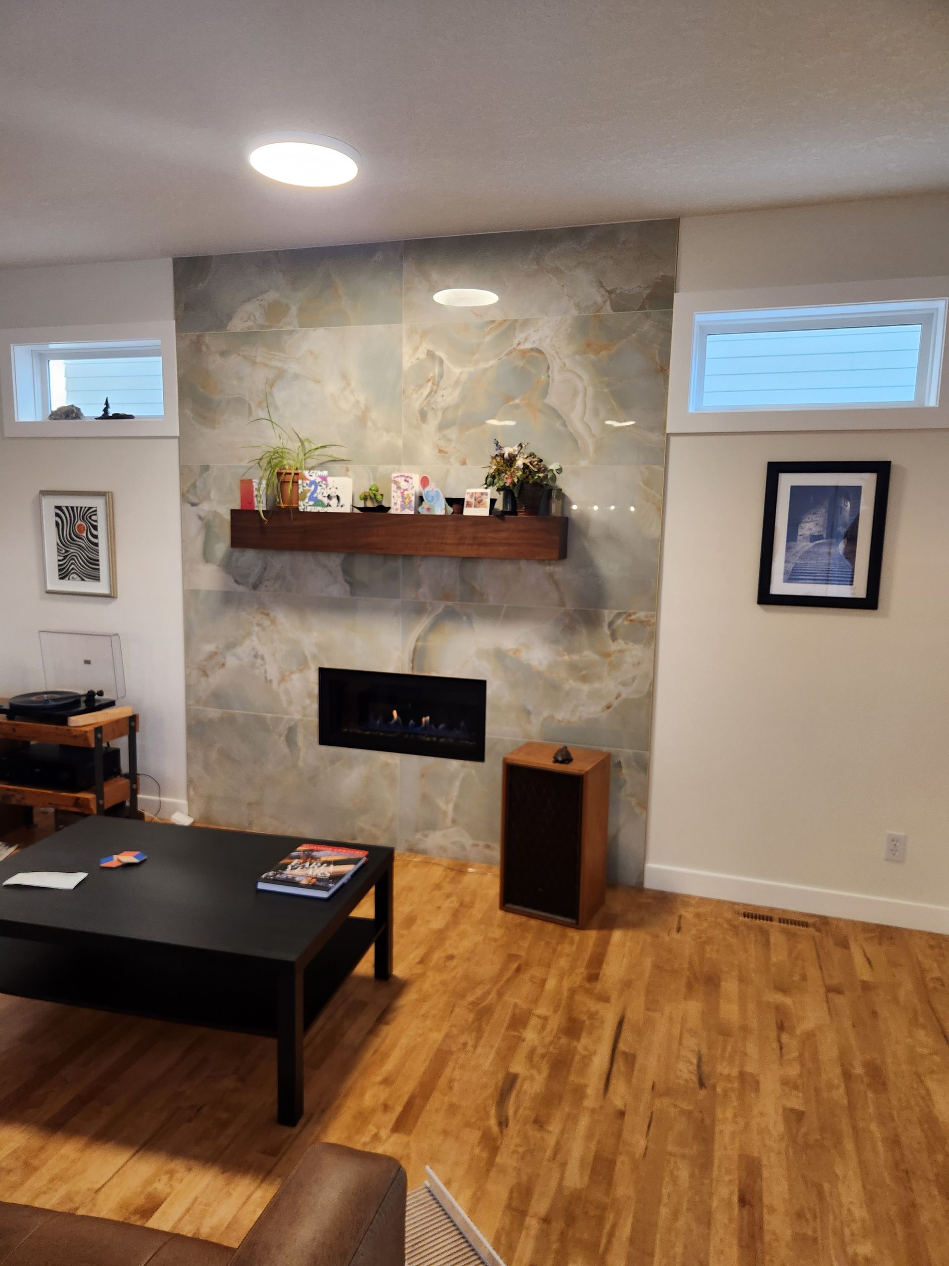 A living room with a fireplace and a coffee table