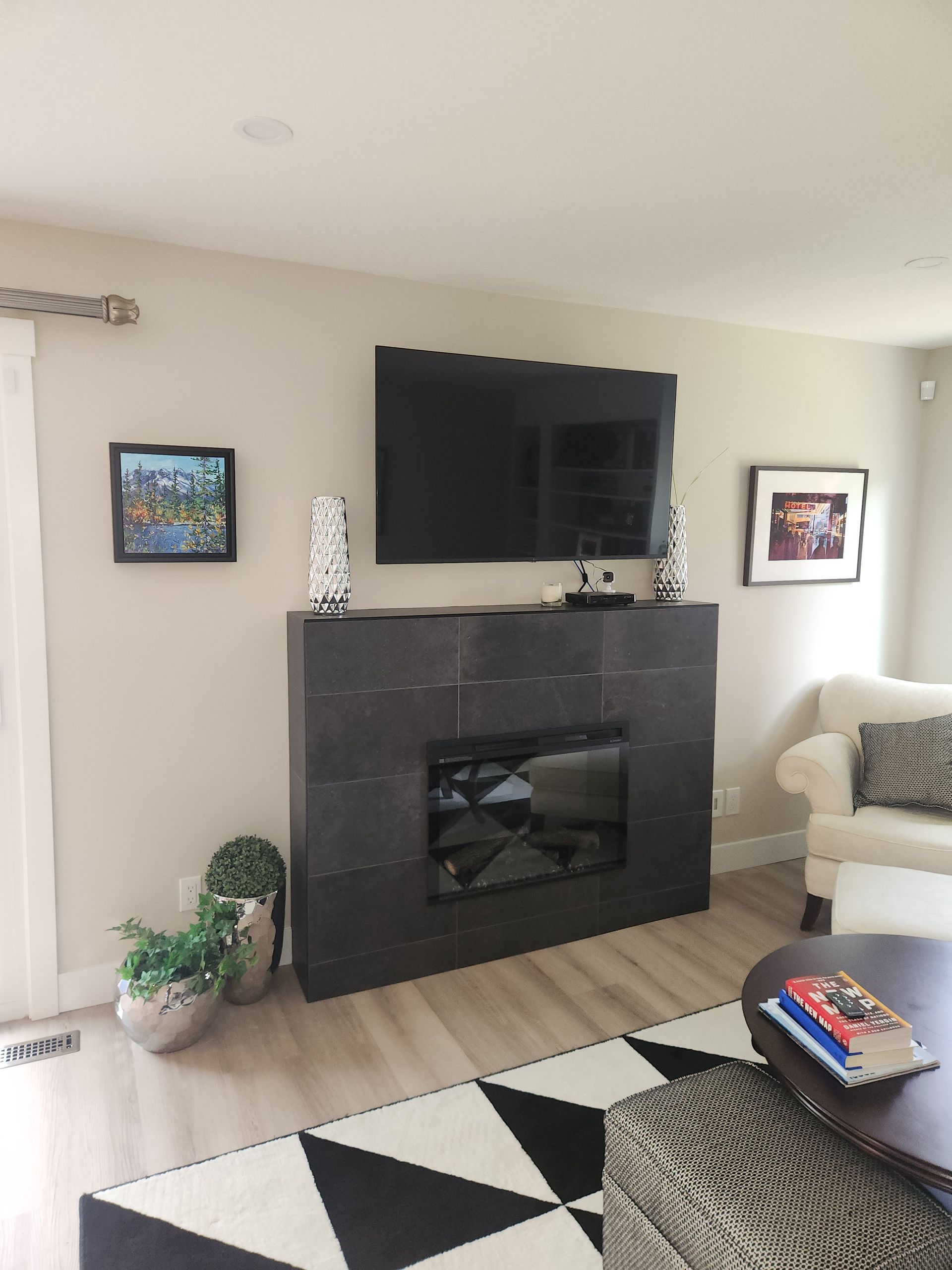 A living room with a fireplace and a flat screen tv