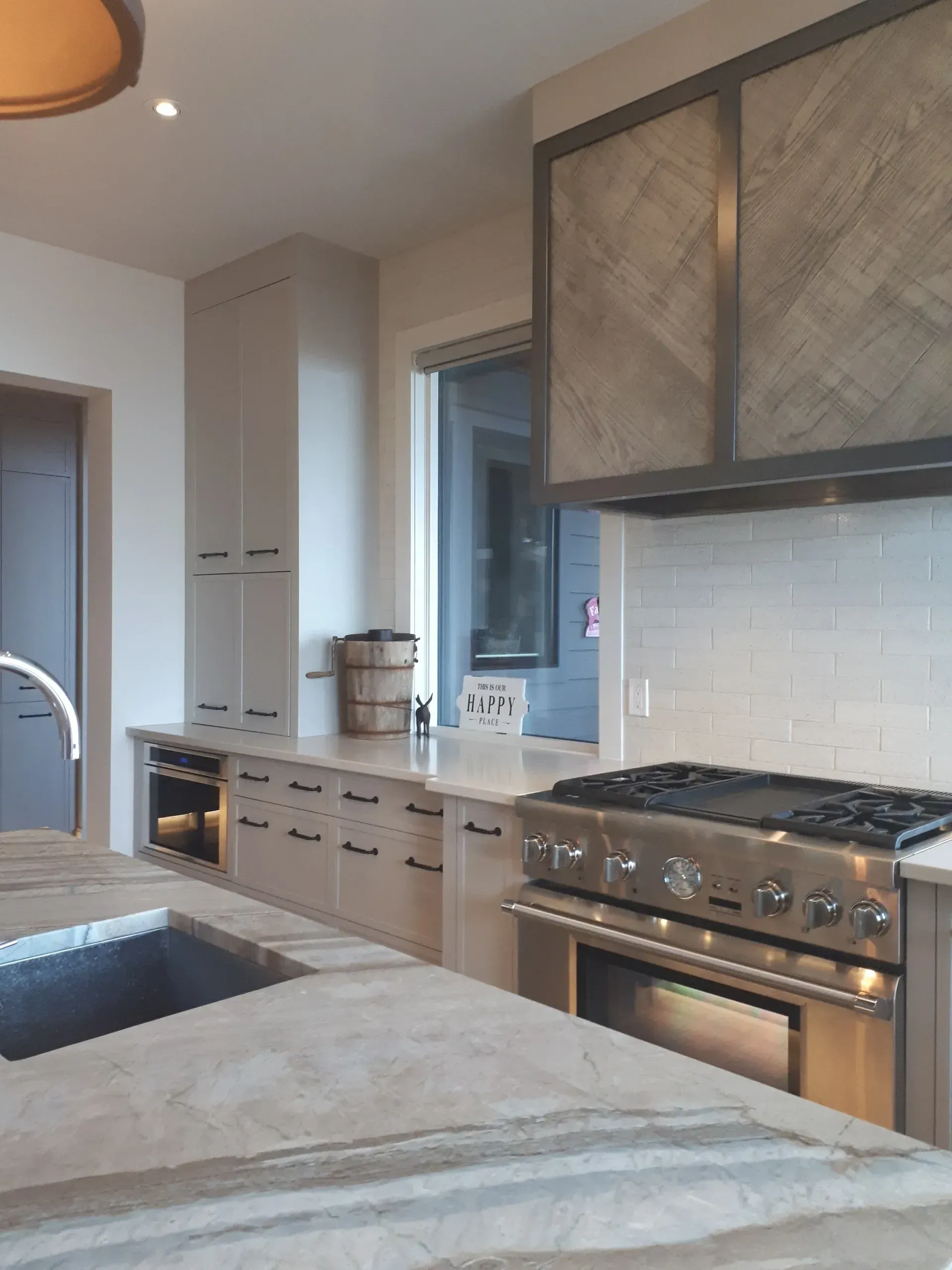A kitchen with a stove top oven and a sink