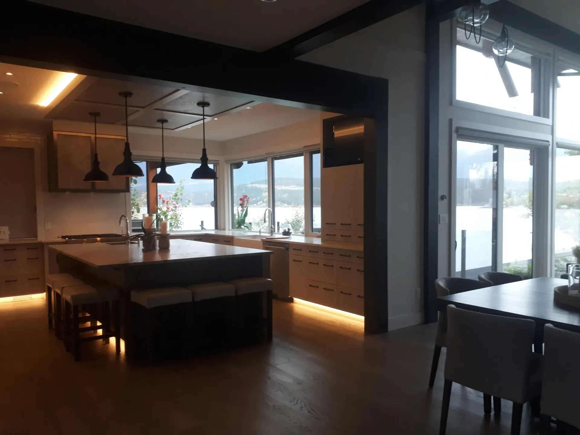 A kitchen with a large island and a dining table