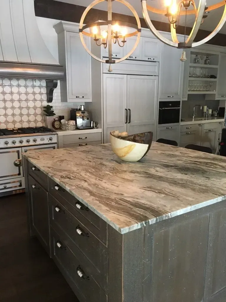 A kitchen with a large island and a bowl on top of it.