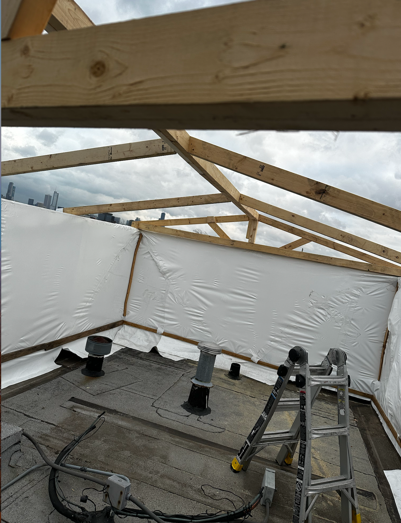 365 Construction tent wall erected, roof framing visible, shrink wrap to be applied