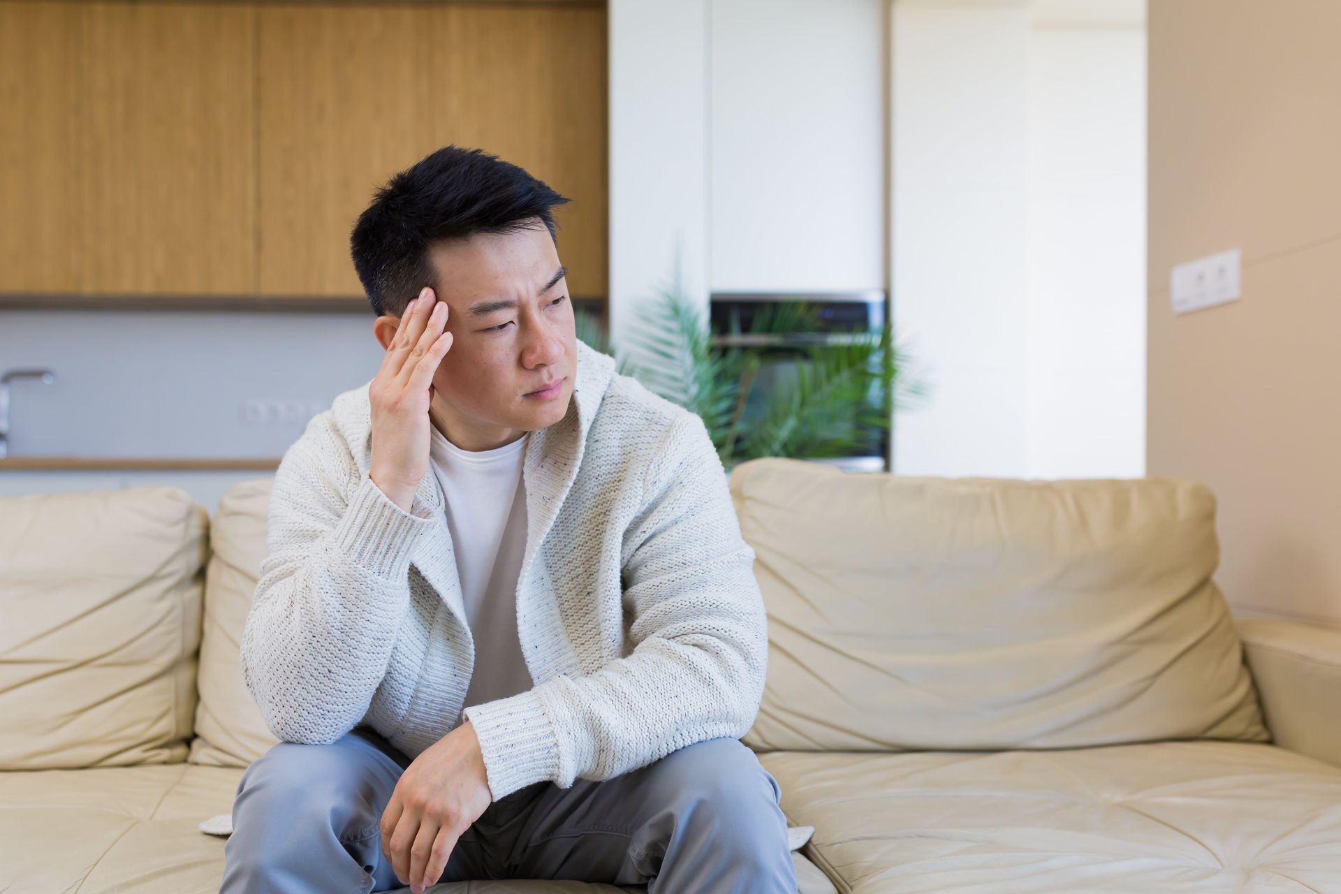 A man is laying on a couch talking to a therapist.