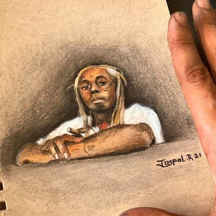 A person is holding a drawing of a man leaning on a wall.