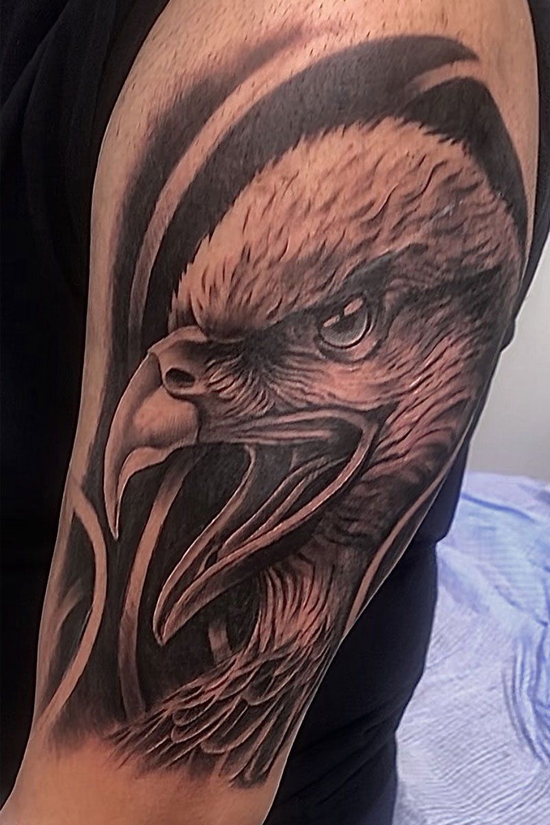 A man has a tattoo of an eagle on his arm