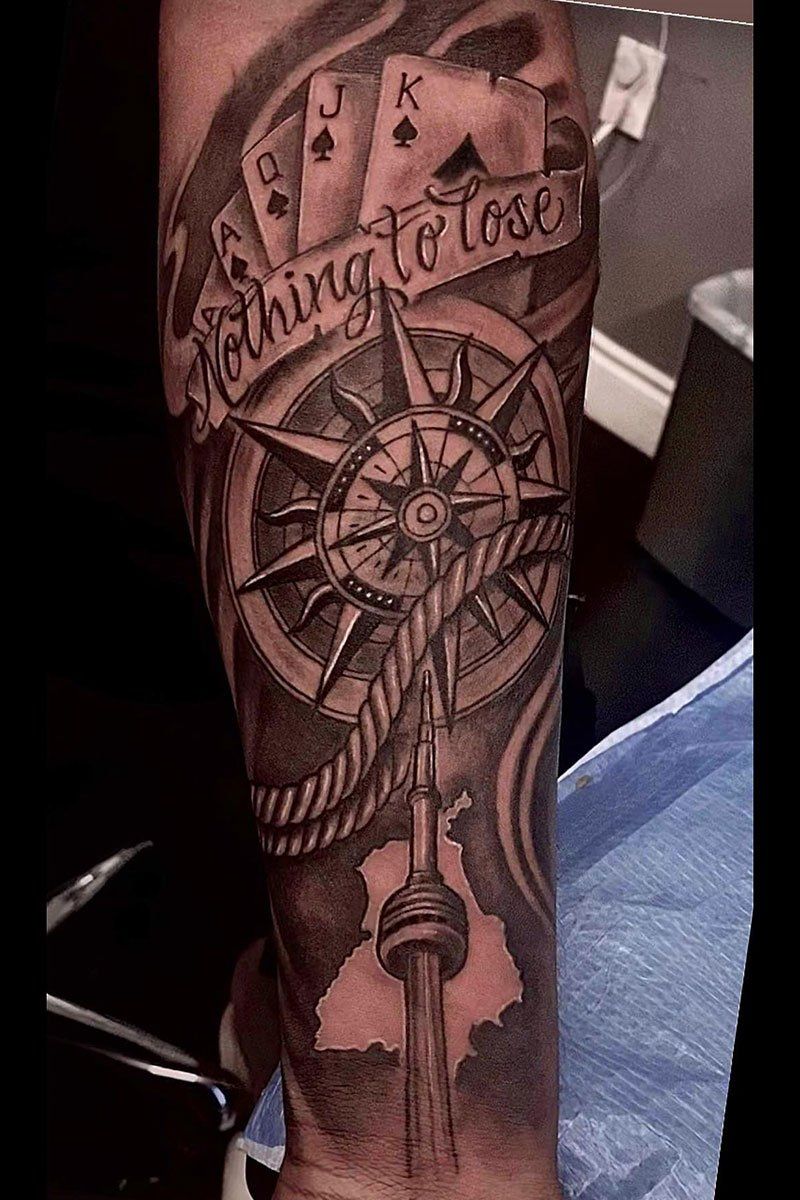 A tattoo on a man 's arm that says nothing to lose
