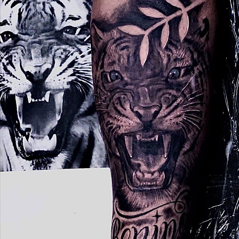 A tattoo of a tiger with a laurel wreath on its head