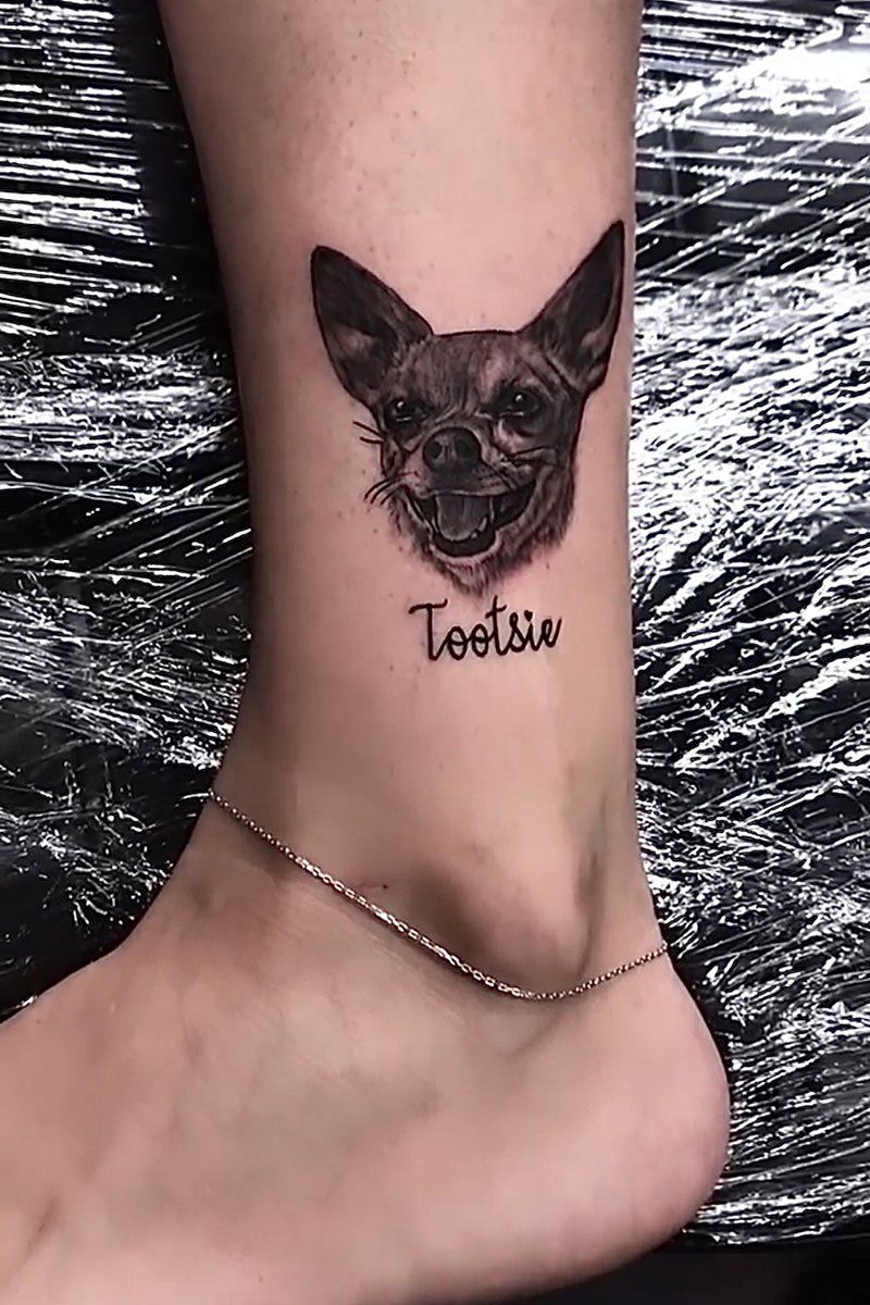 A person has a tattoo of a chihuahua on their ankle