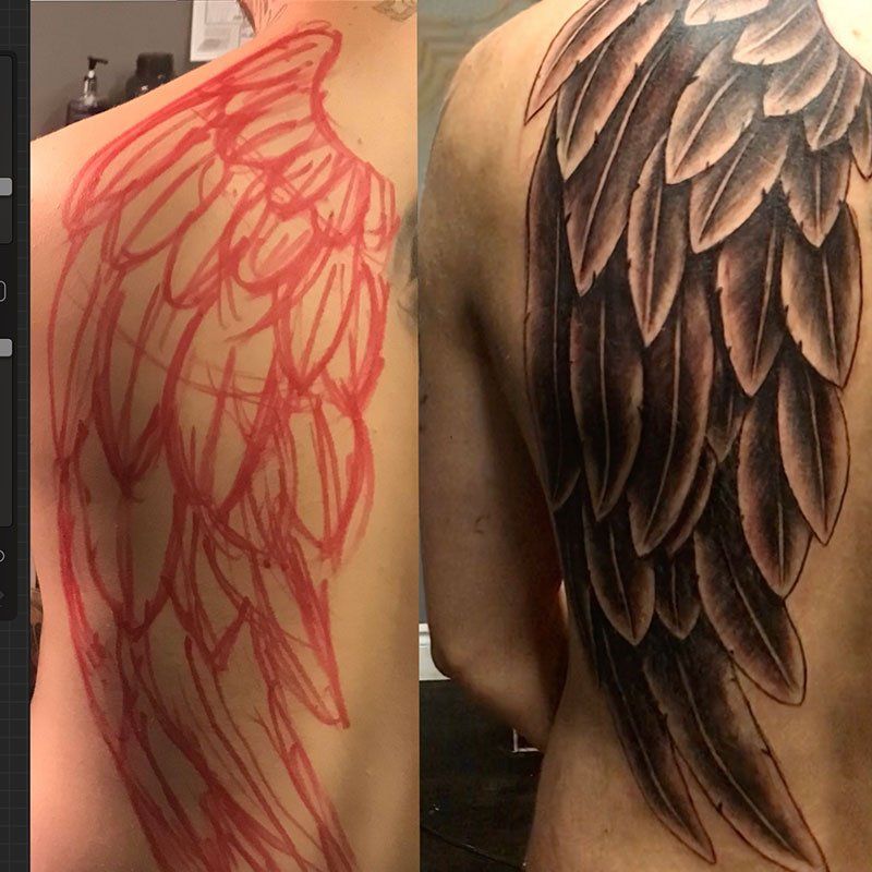 A man has a tattoo of angel wings on his back