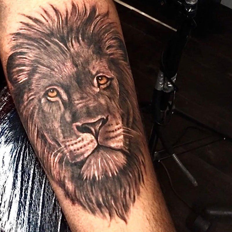 A man has a tattoo of a lion on his arm