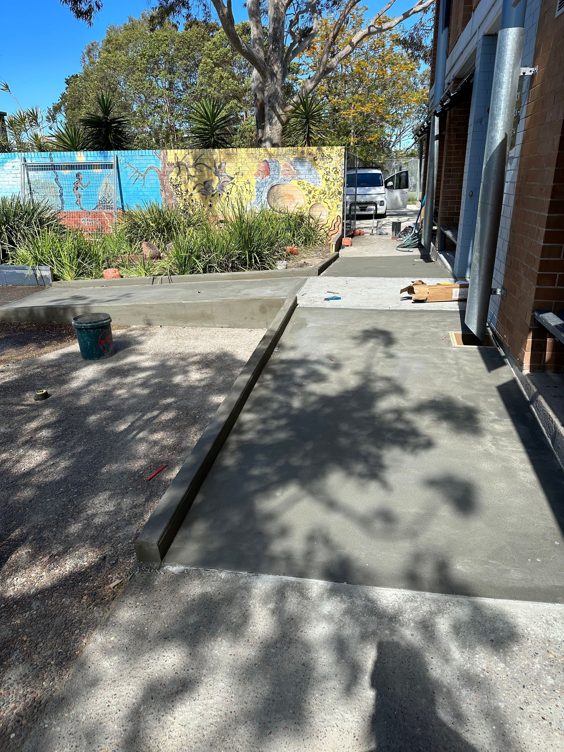 A large concrete slab is sitting in the middle of a grassy field.