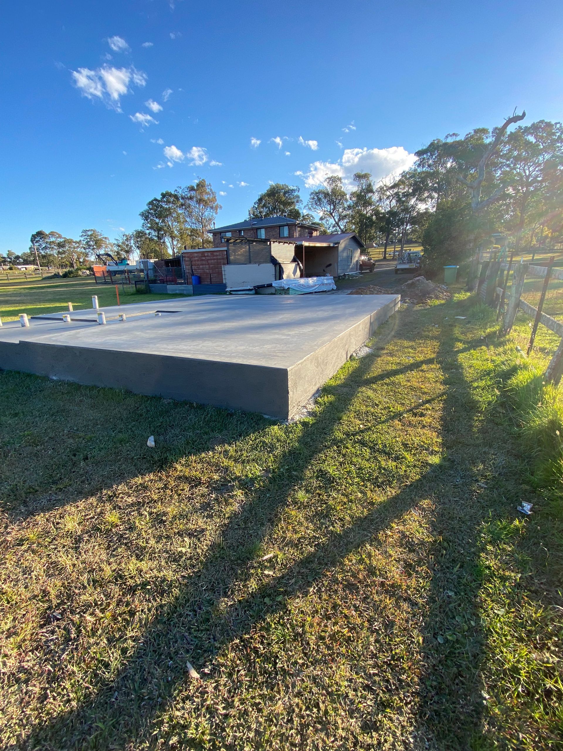 A large concrete slab is sitting in the middle of a grassy field.