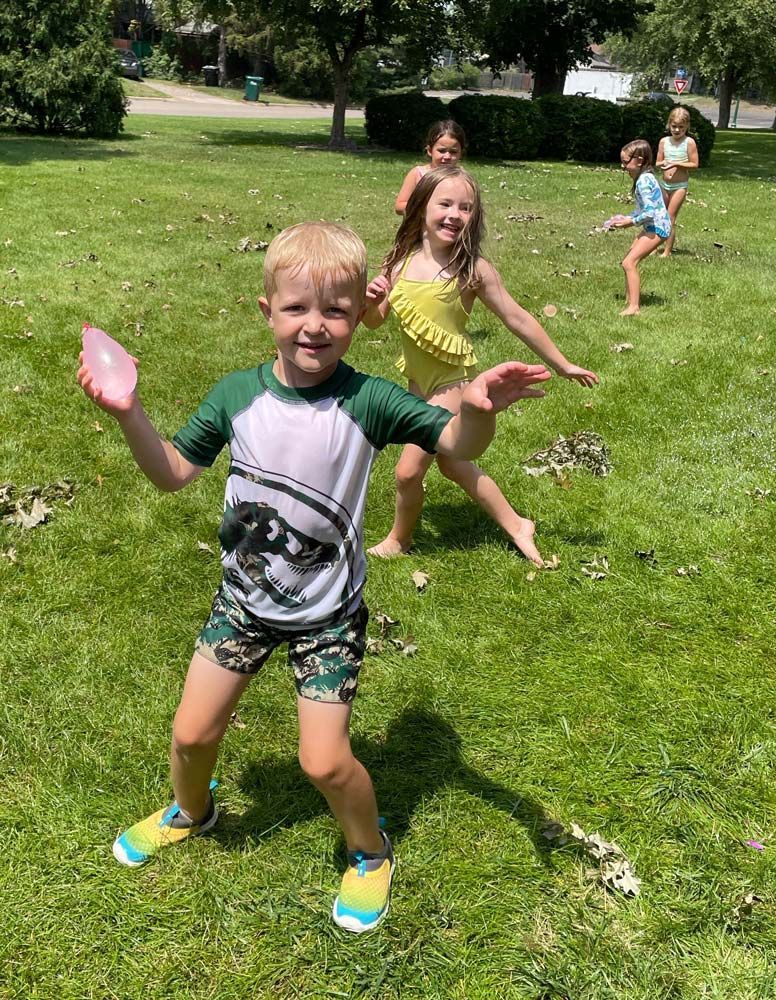 A group of children are playing frisbee in a park.