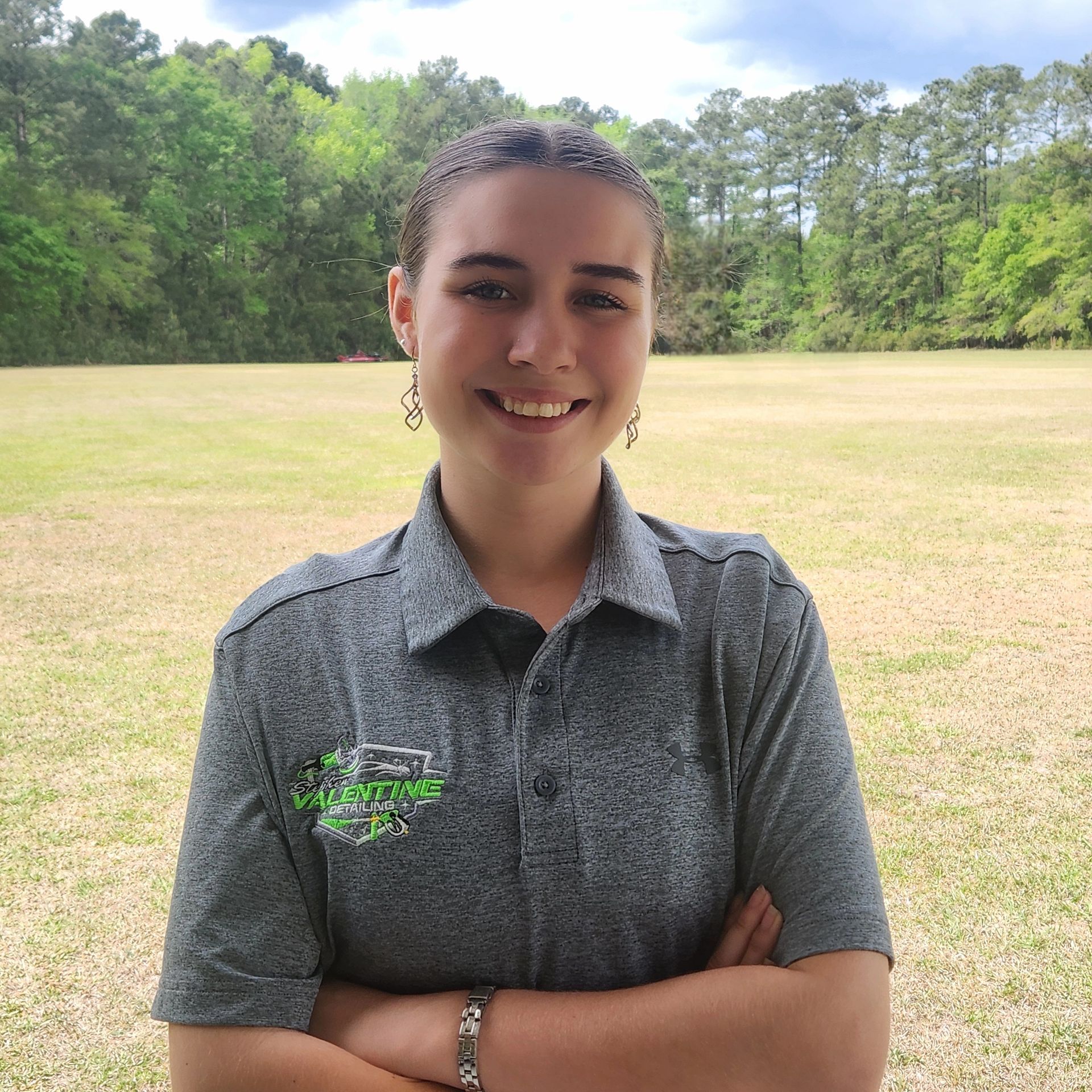 A Person in a Black Jumpsuit Washes a White Car Covered in Soap — Valentine Detailing LLC in Walterboro, SC