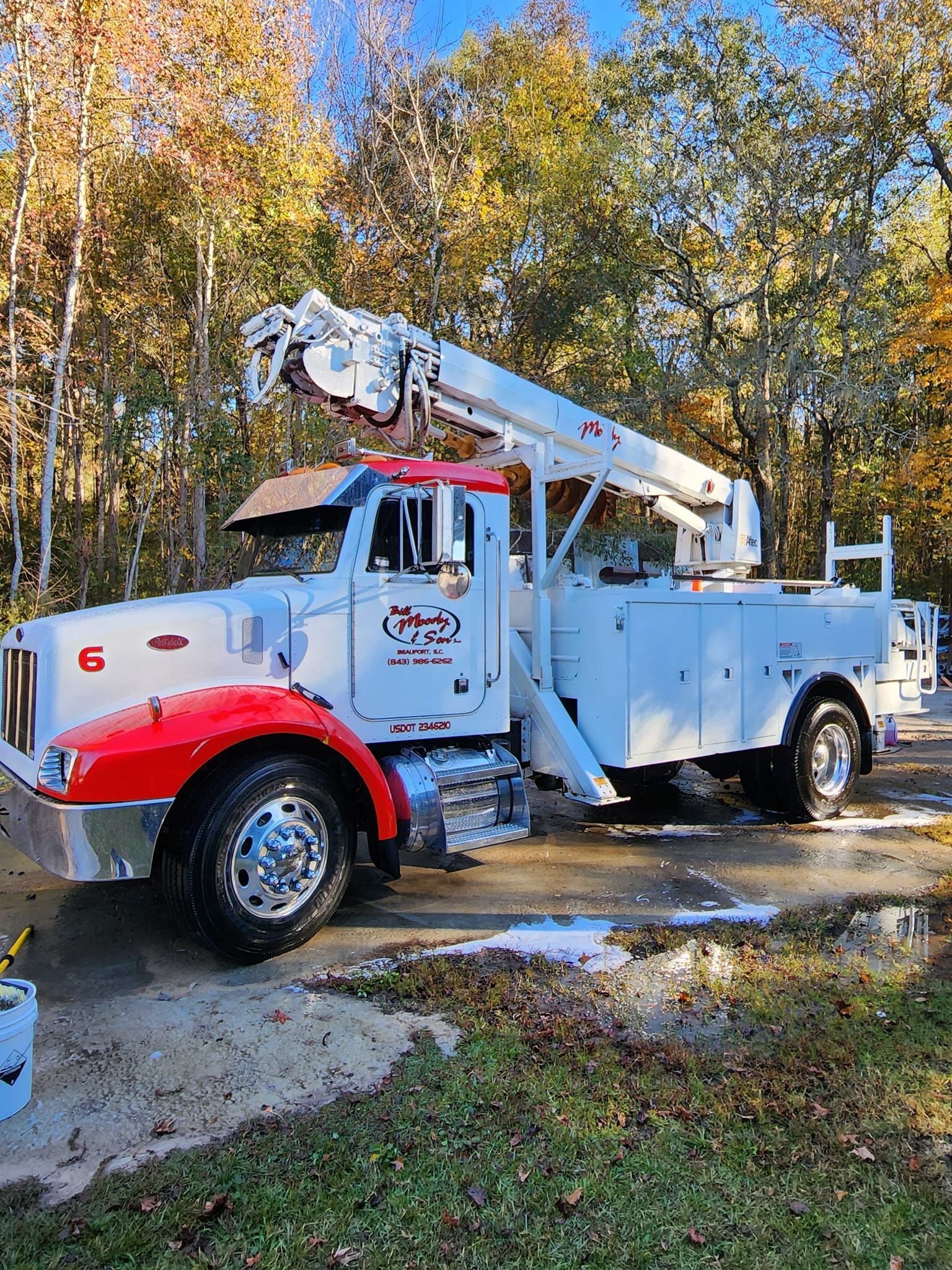 A White Utility Truck Parked on a Paved Driveway Near Autumn Trees — Valentine Detailing LLC in Walterboro, SC