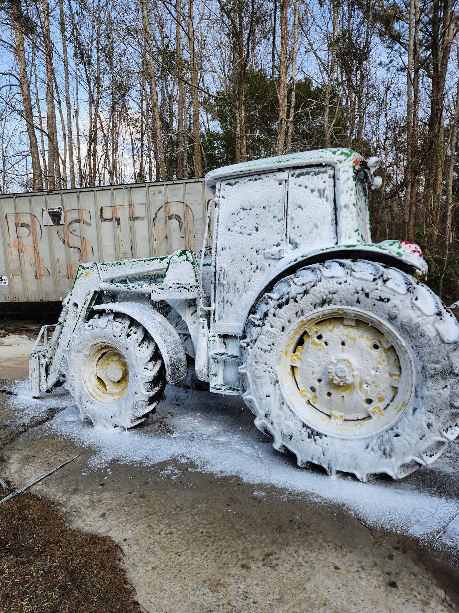 A Tractor Parked Outdoors, Covered in Thick White Cleaning Foam — Valentine Detailing LLC in Walterboro, SC
