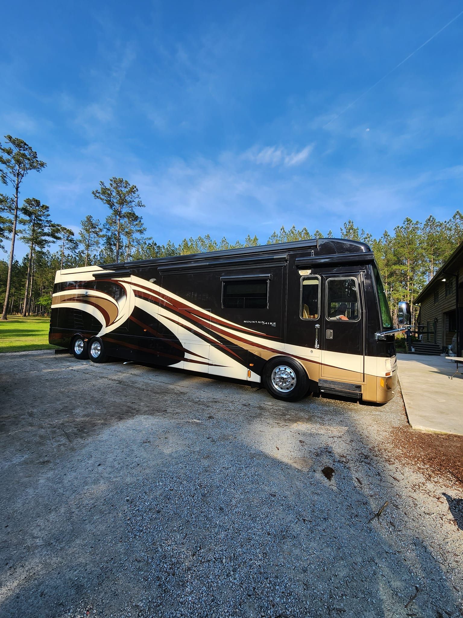 A Modern Black and Tan Recreational Vehicle Parked on a Gravel Lot — Valentine Detailing LLC in Walterboro, SC