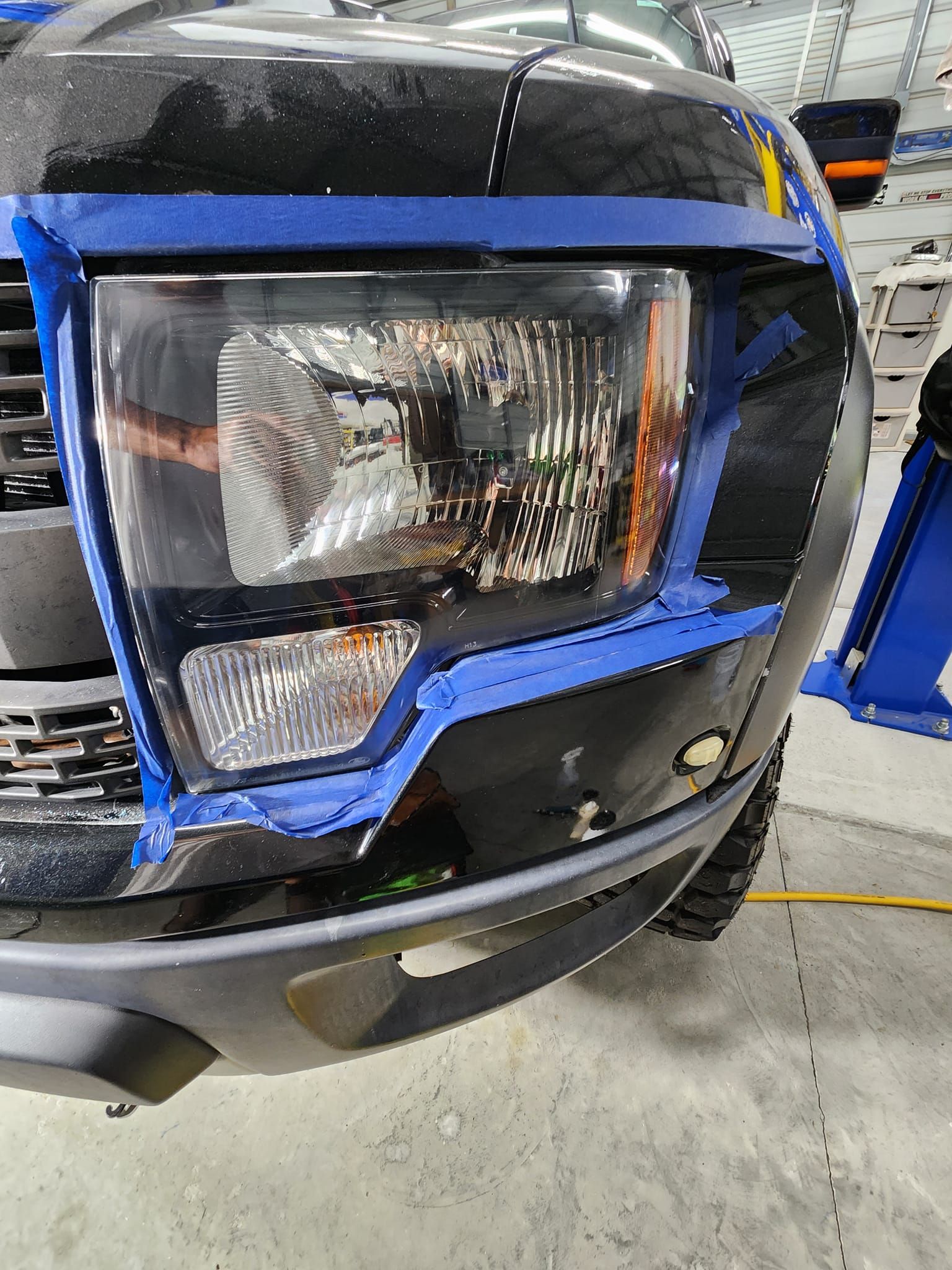 A Black Truck Headlight Taped With Blue Painter's Tape — Valentine Detailing LLC in Walterboro, SC