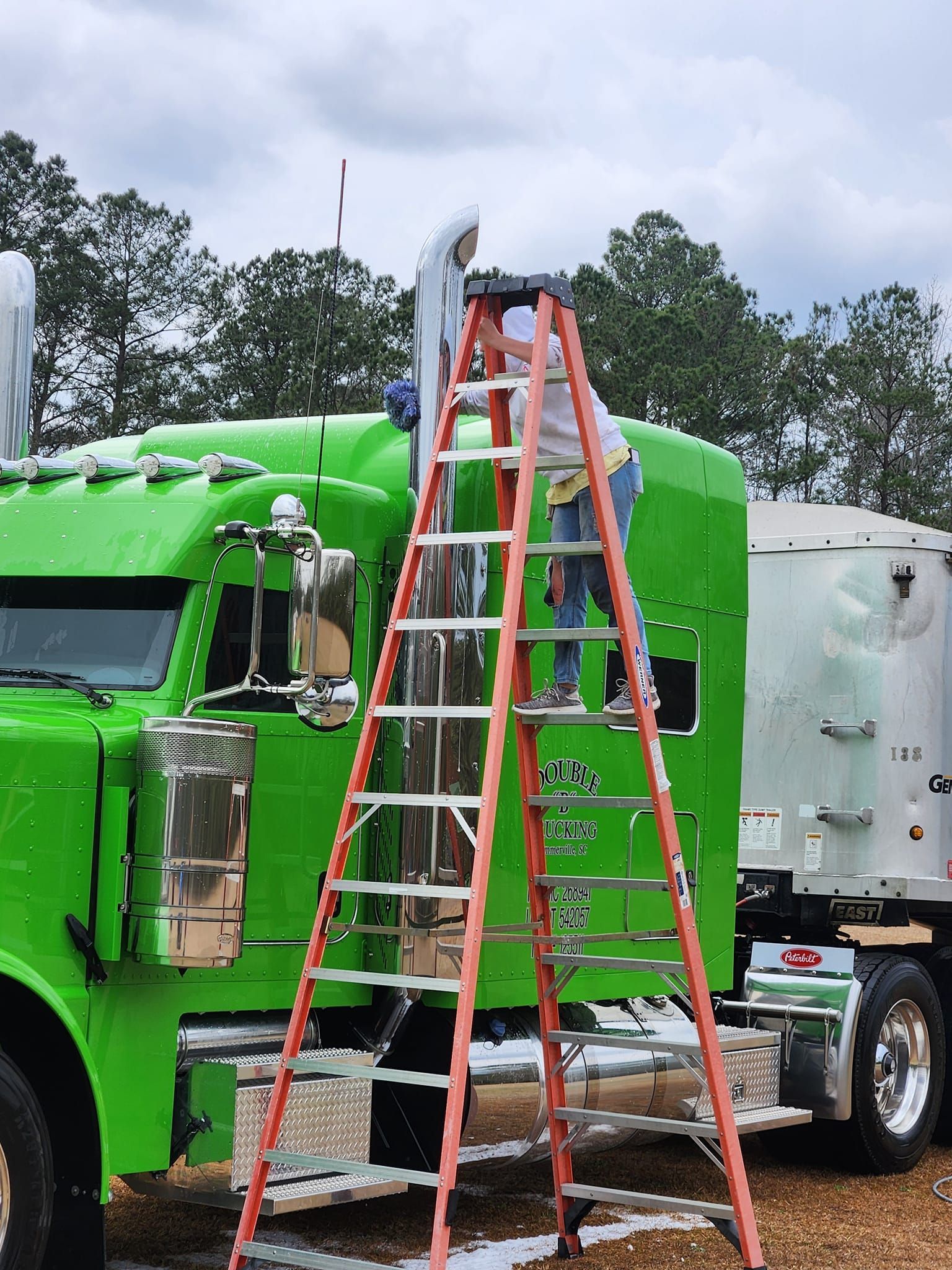 A Person Soaps and Washes a Dark Semi-truck — Valentine Detailing LLC in Walterboro, SC