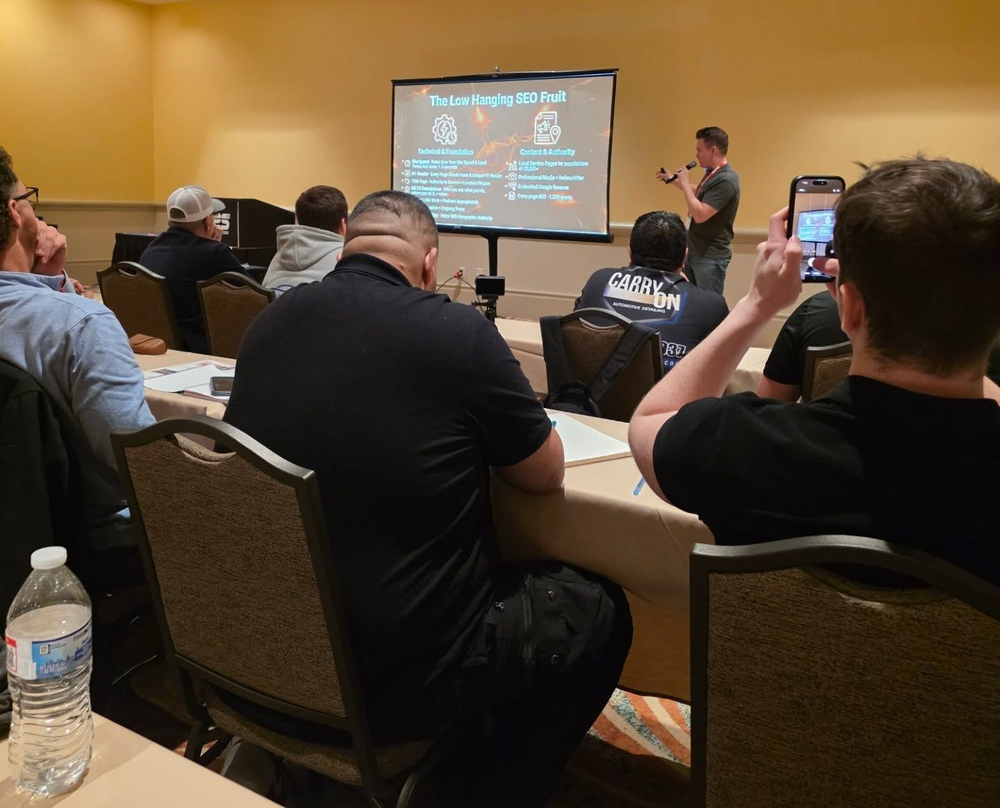 A Group of People Sits at Tables in a Meeting Room — Valentine Detailing LLC in Walterboro, SC