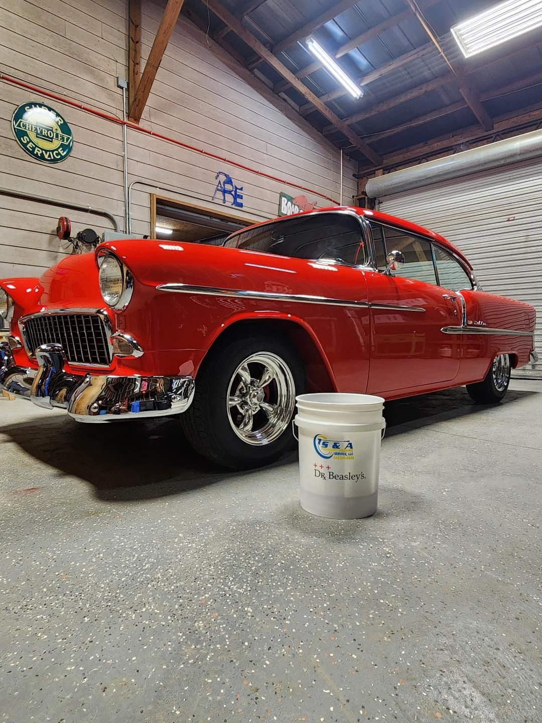 A Bright Red Vintage 1955 Chevrolet Parked in a Garage With a White Bucket — Valentine Detailing LLC in Walterboro, SC