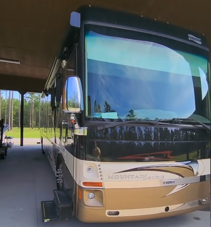 A Black and Gold Mountain Aire Motorhome Parked Under a Carport — Valentine Detailing LLC in Walterboro, SC