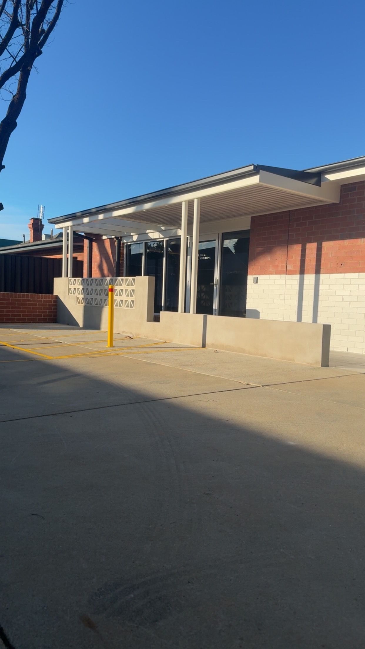 Brick Building With White Pergola— Absolute Steel Fabrication & Welding In East Wagga Wagga, NSW