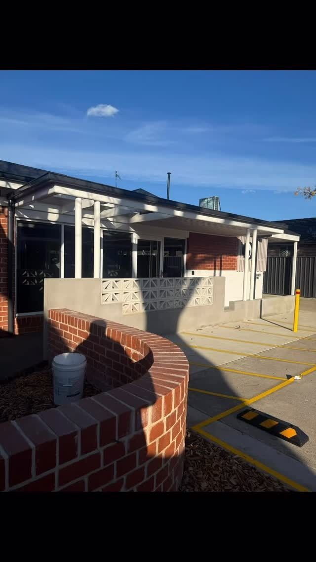 Red Brick Building With a White Pergola and a Curved Brick Wall — Absolute Steel Fabrication & Welding In East Wagga Wagga, NSW