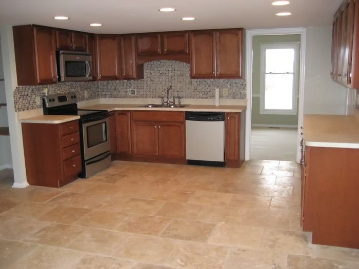 A kitchen with wooden cabinets and stainless steel appliances