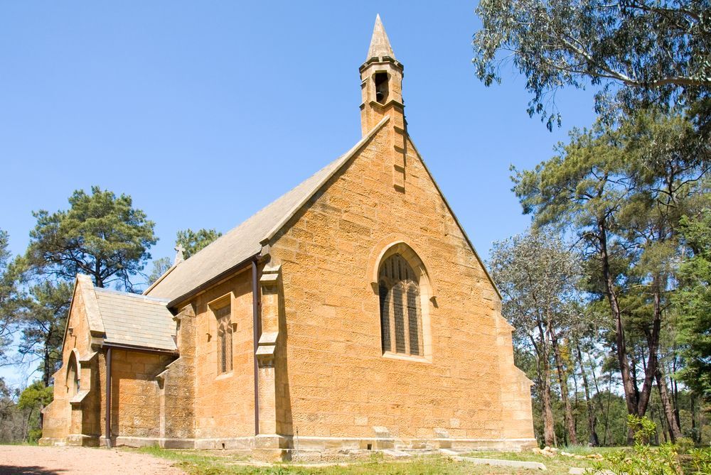 A Small Brick Church Surrounded By Trees — GMT Builders Pty Ltd in Berrima, NSW