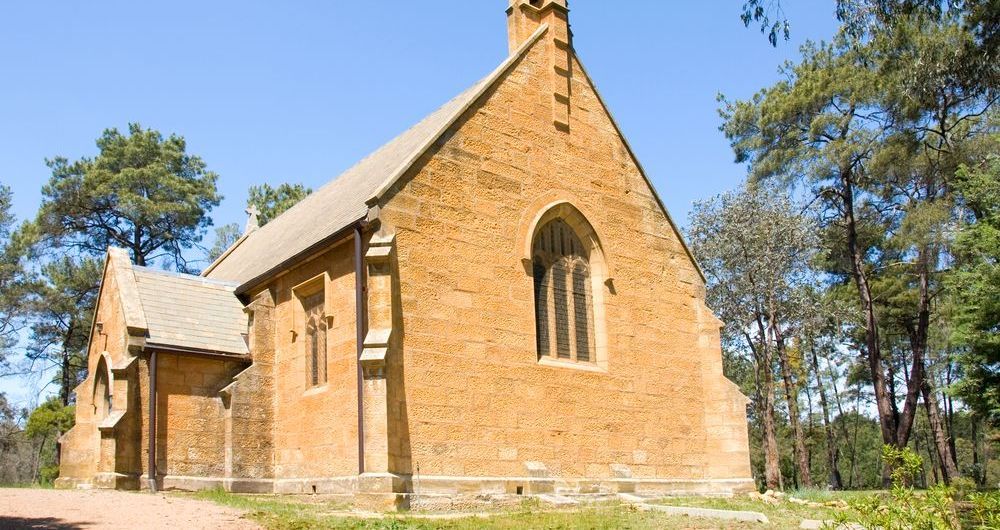 A Small Brick Church Surrounded By Trees — GMT Builders Pty Ltd in Berrima, NSW