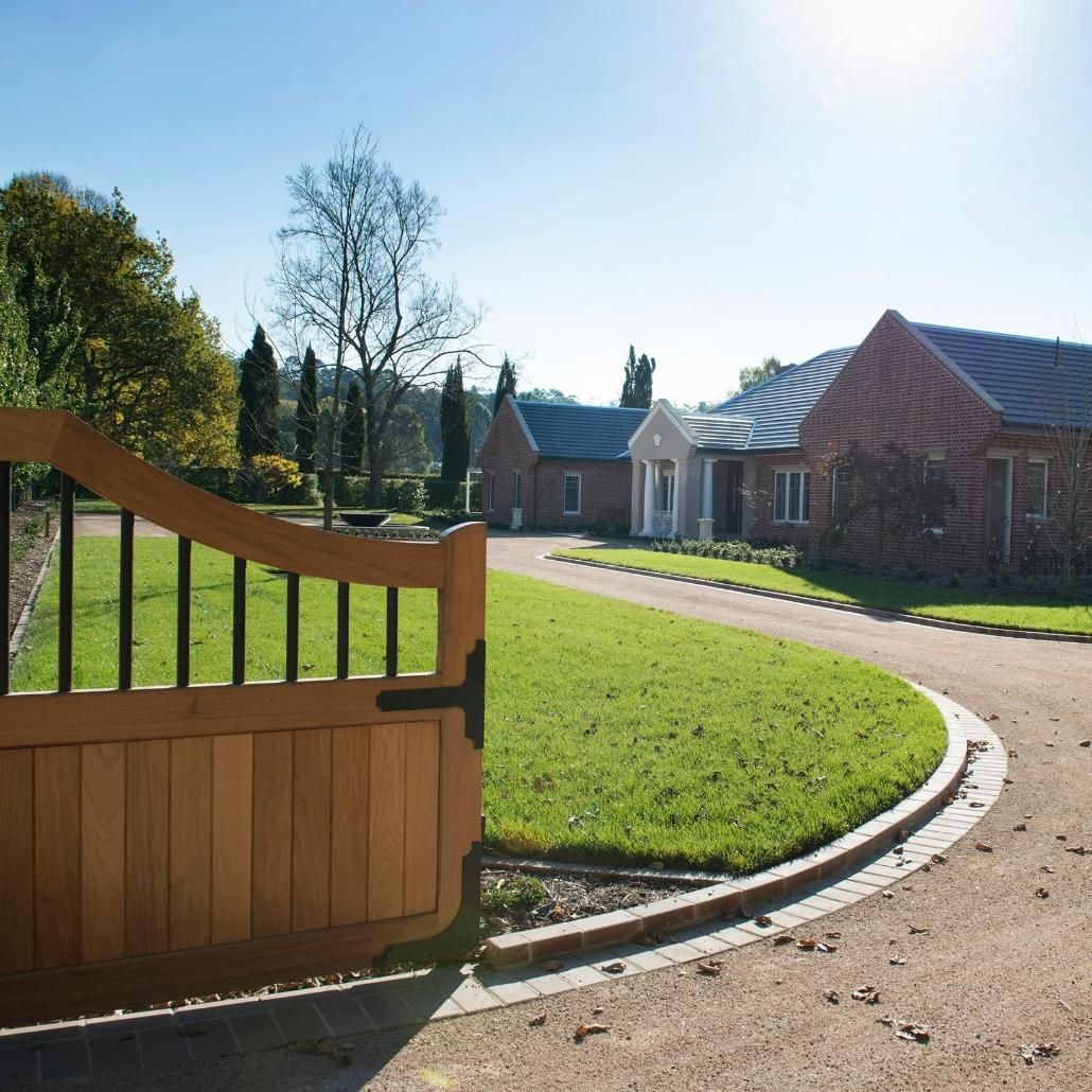 An View of A Large House with driveway and large gate  — GMT Builders Pty Ltd in Burradoo, NSW