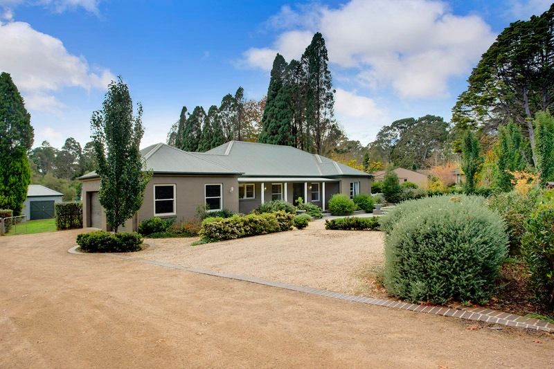 An Front View of A House surrounded by a garden in A Field — GMT Builders Pty Ltd in Mittagong, NSW