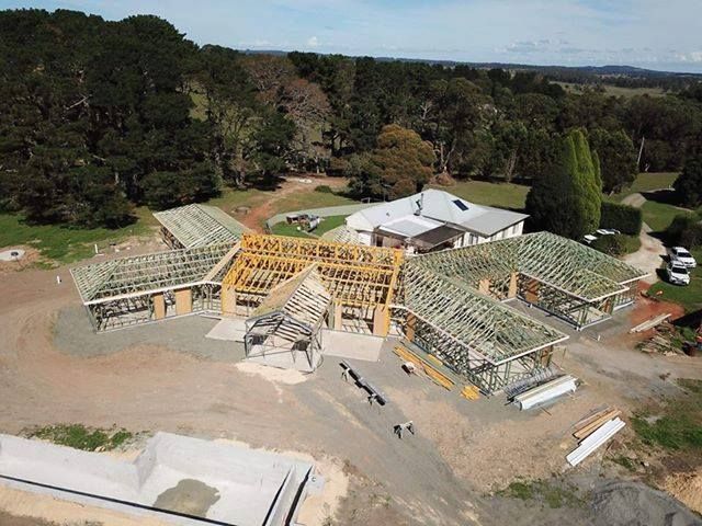 An Aerial View of A House Under Construction in The Middle of A Forest — GMT Builders Pty Ltd in Bowral, NSW