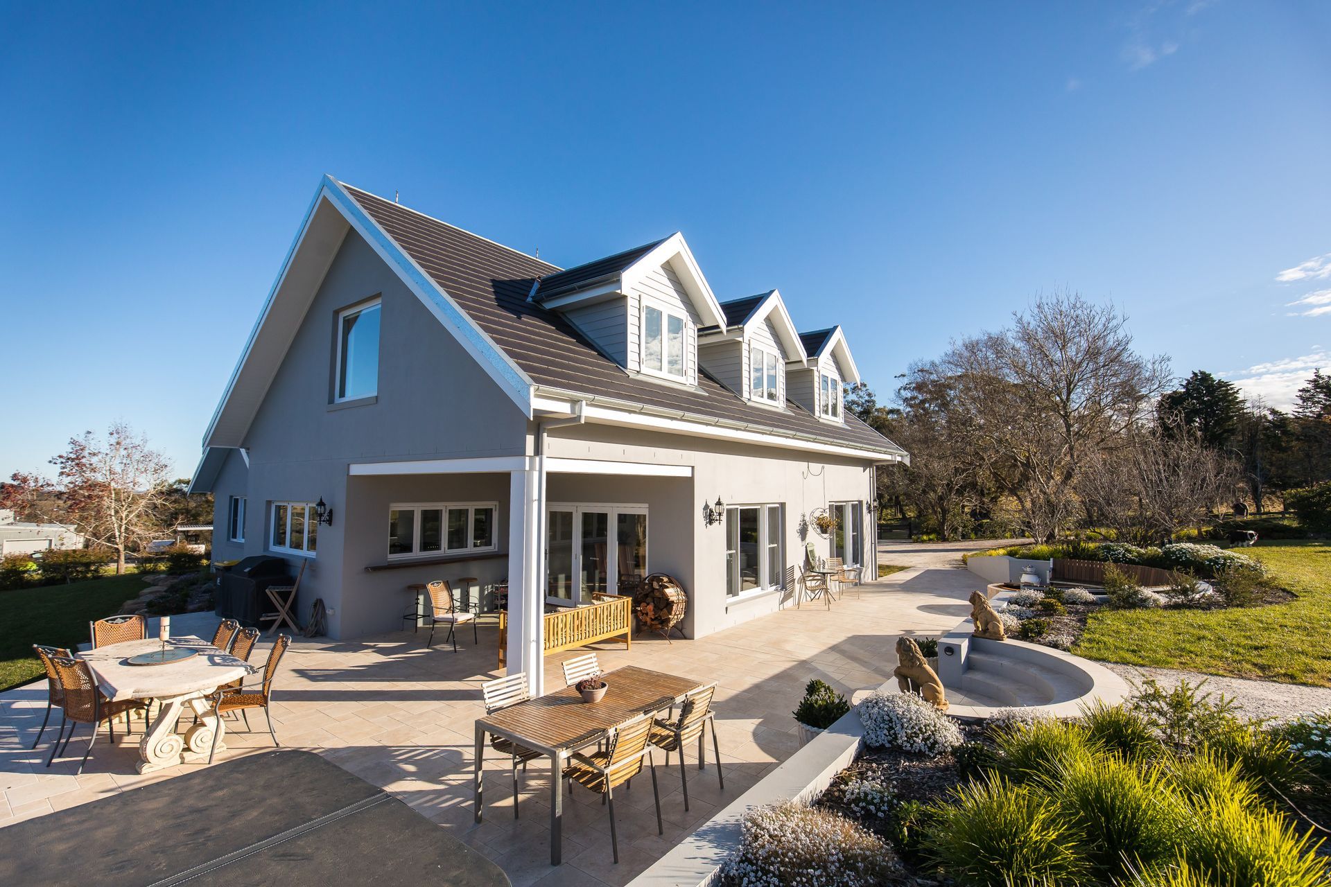A large house with a patio and a table and chairs in front of it — GMT Builders Pty Ltd in Badine, NSW