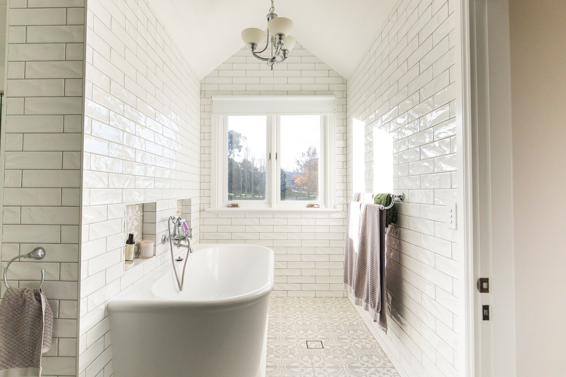 A bathroom with white brick walls and a bathtub — GMT Builders Pty Ltd in Badine, NSW
