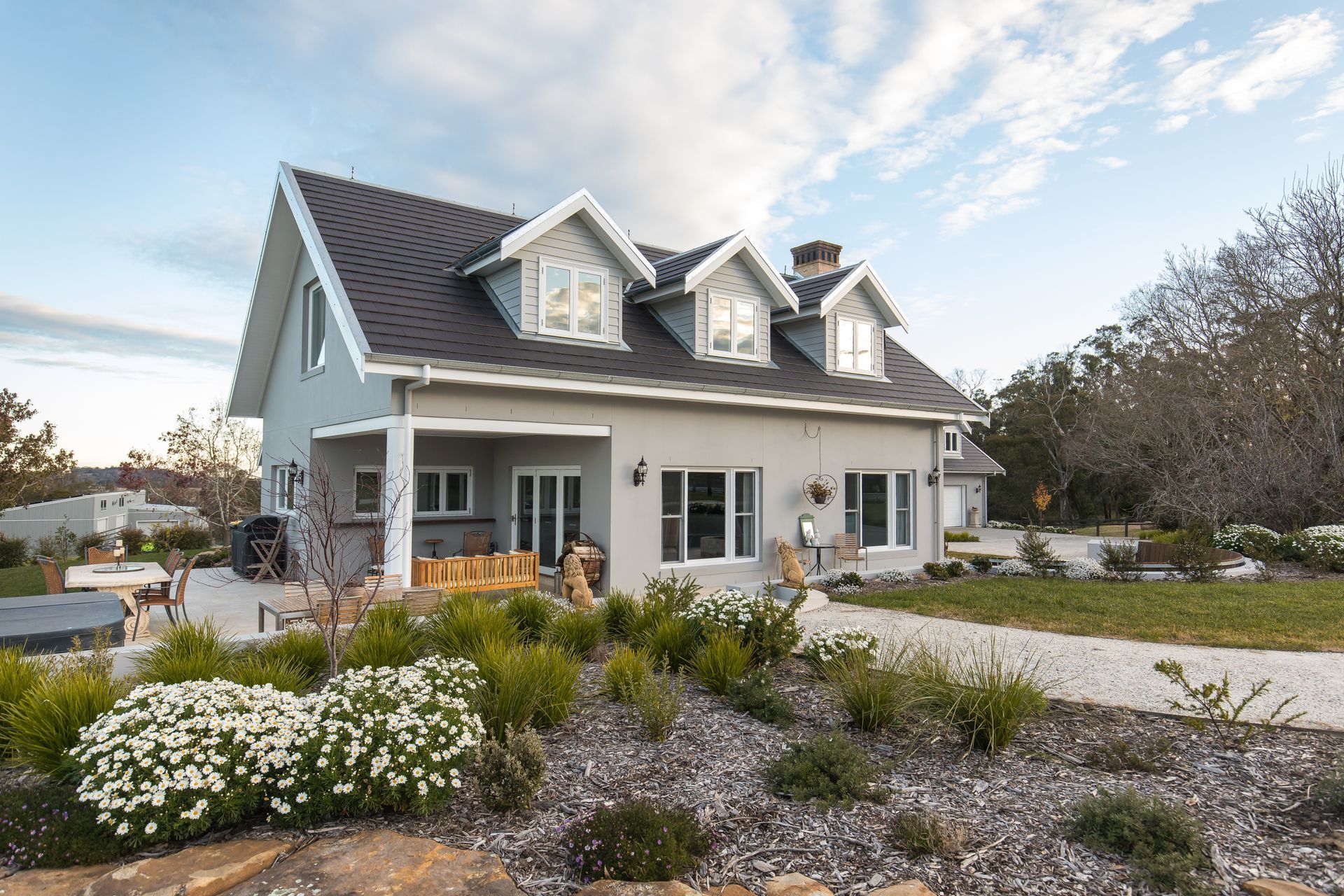 A Black and White House with A Driveway in Front of It — GMT Builders Pty Ltd in Berrima, NSW