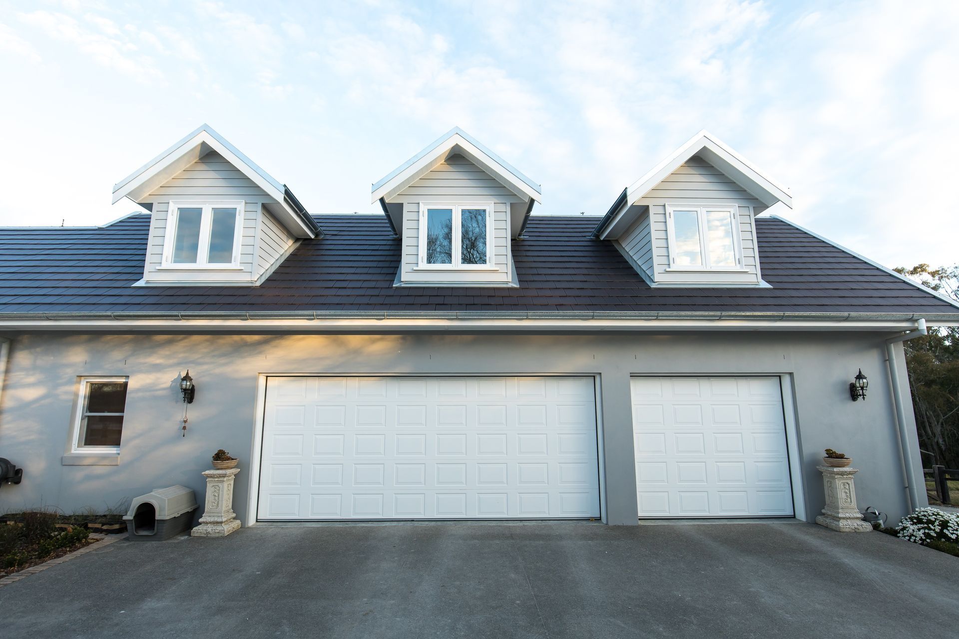 A house with two garage doors and a black roof — GMT Builders Pty Ltd in Berrima, NSW